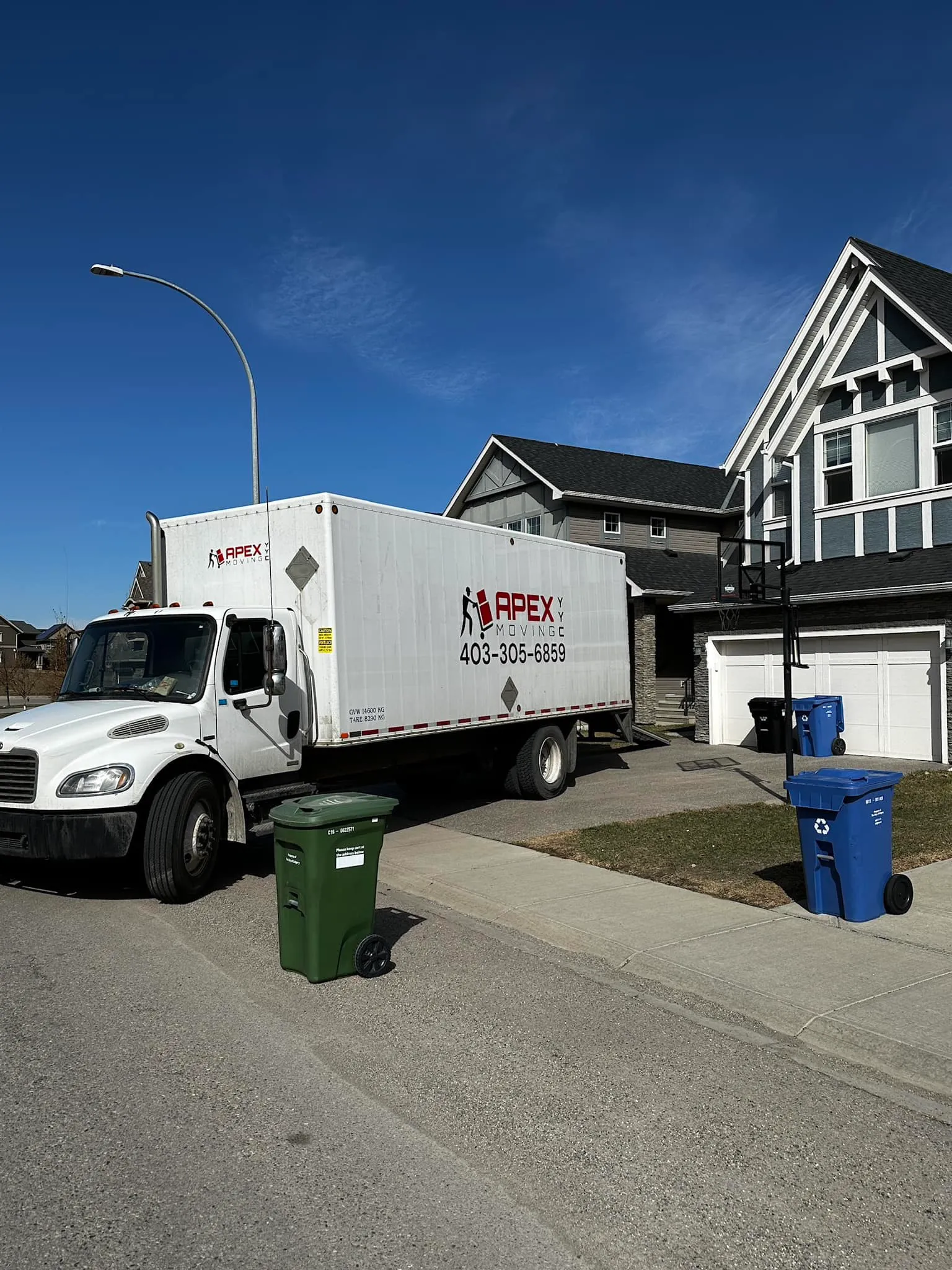 Apex Moving YYC - a moving truck parked & ready in front of a client's house in Calgary, AB, Canada